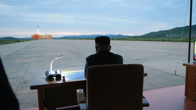 North Korean President Kim Jong-un watching a ballistic missile launch.