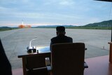 North Korean President Kim Jong-un watching a ballistic missile launch.