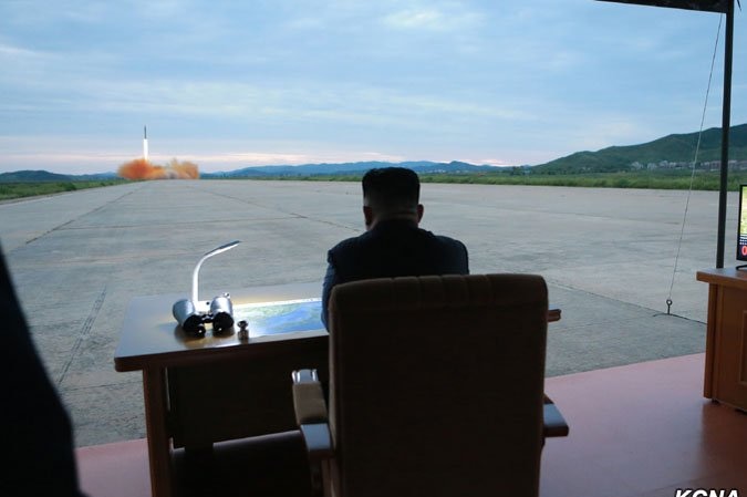 North Korean President Kim Jong-un watching a ballistic missile launch.