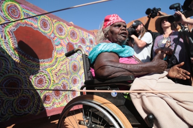 Nelly Patterson is in a wheelchair and talks to the media. There is cameras around her.