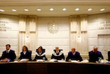 Members of Austria's constitutional court wait for the start of a court session
