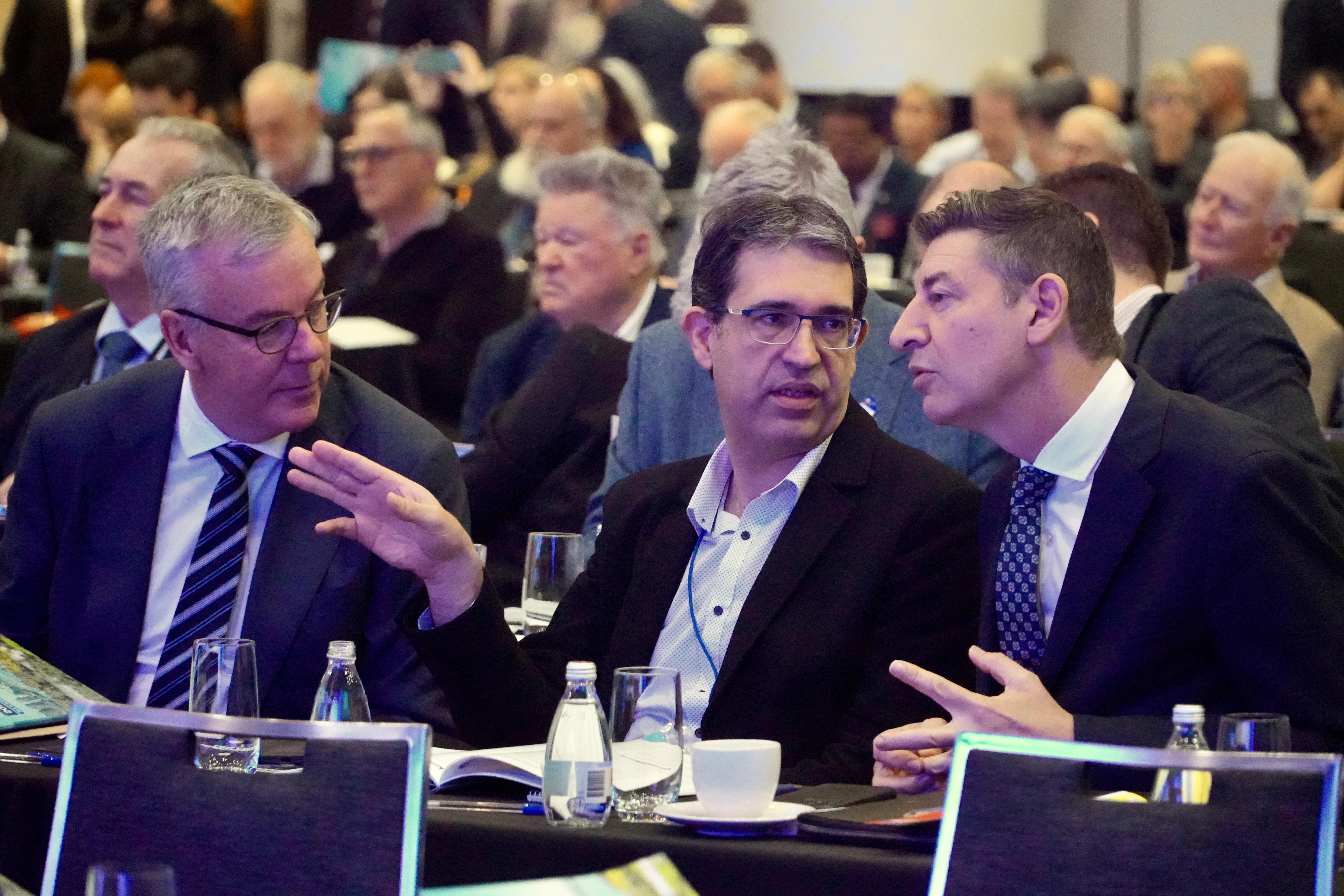 Basil leans in towards Nick Goiran as the speak to each other at a conference