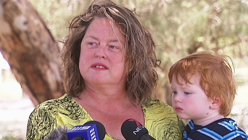 Nat Cook Labor Fisher holding her child Dec 13 2014