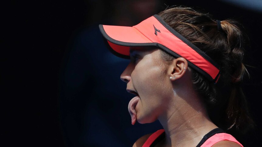 Lauren Davis sticks out her tongue during her third-round match against Simona Halep at the Australian Open.