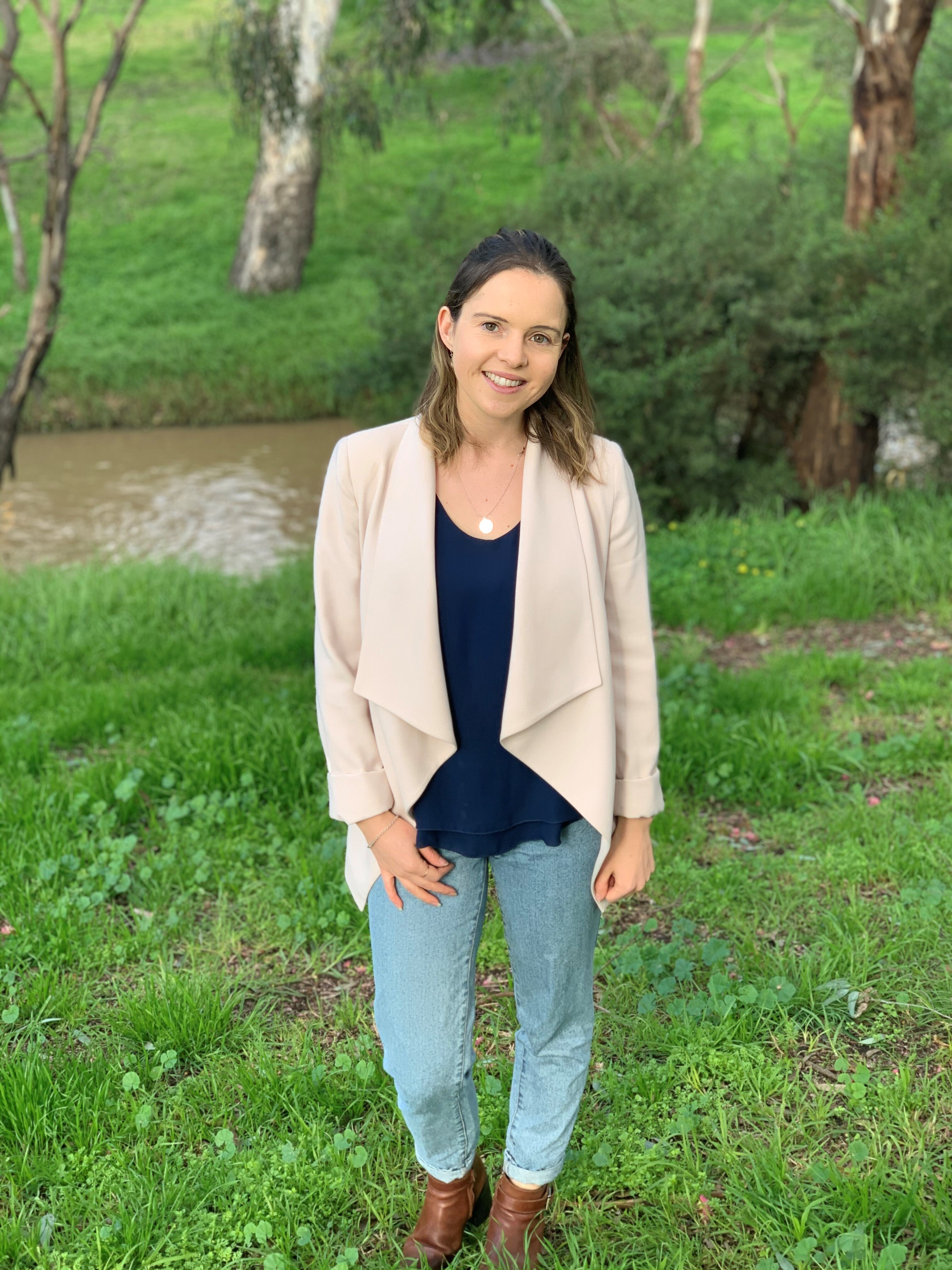 Moreland Mayor Annalivia Carli-Hannan smiles for a photo near a creek.