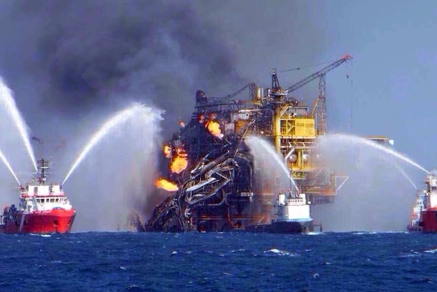 Crews try to put out a fire that erupted on an offshore oil platform in the Gulf of Mexico