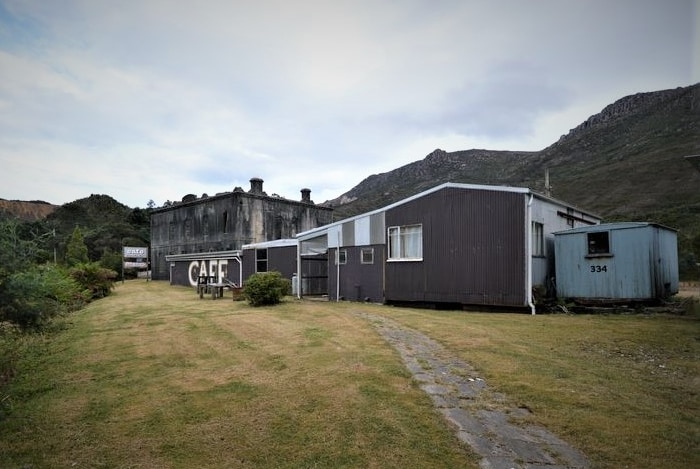 Exterior of an old pub and buildings.