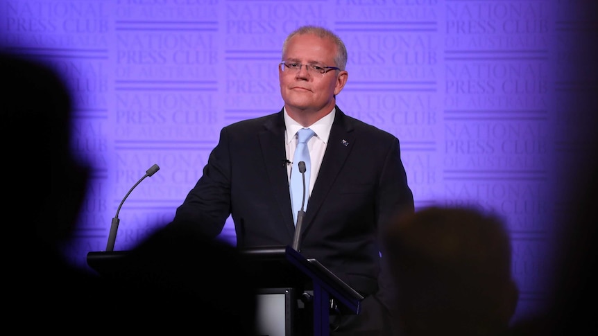 Scott Morrison stands at a National Press Club podium answering debate questions