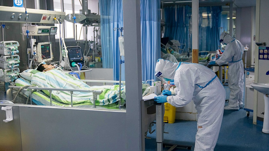 A medical worker attends to a patient in an intensive care unit at Wuhan University.