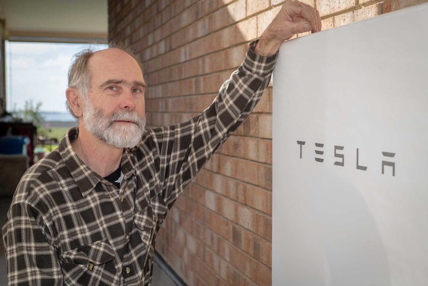 Rolf Wittwer leans on his Tesla battery.