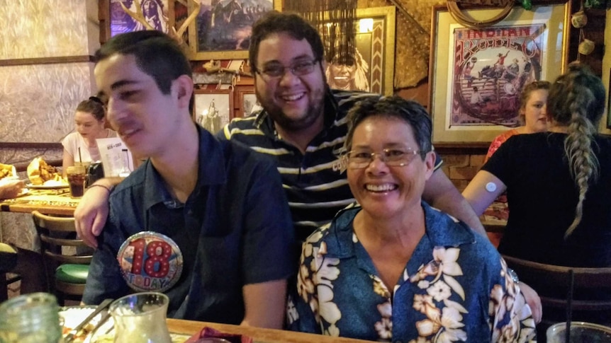 Cynthia and her two sons at a restaurant to celebrate Austin's 18th birthday.