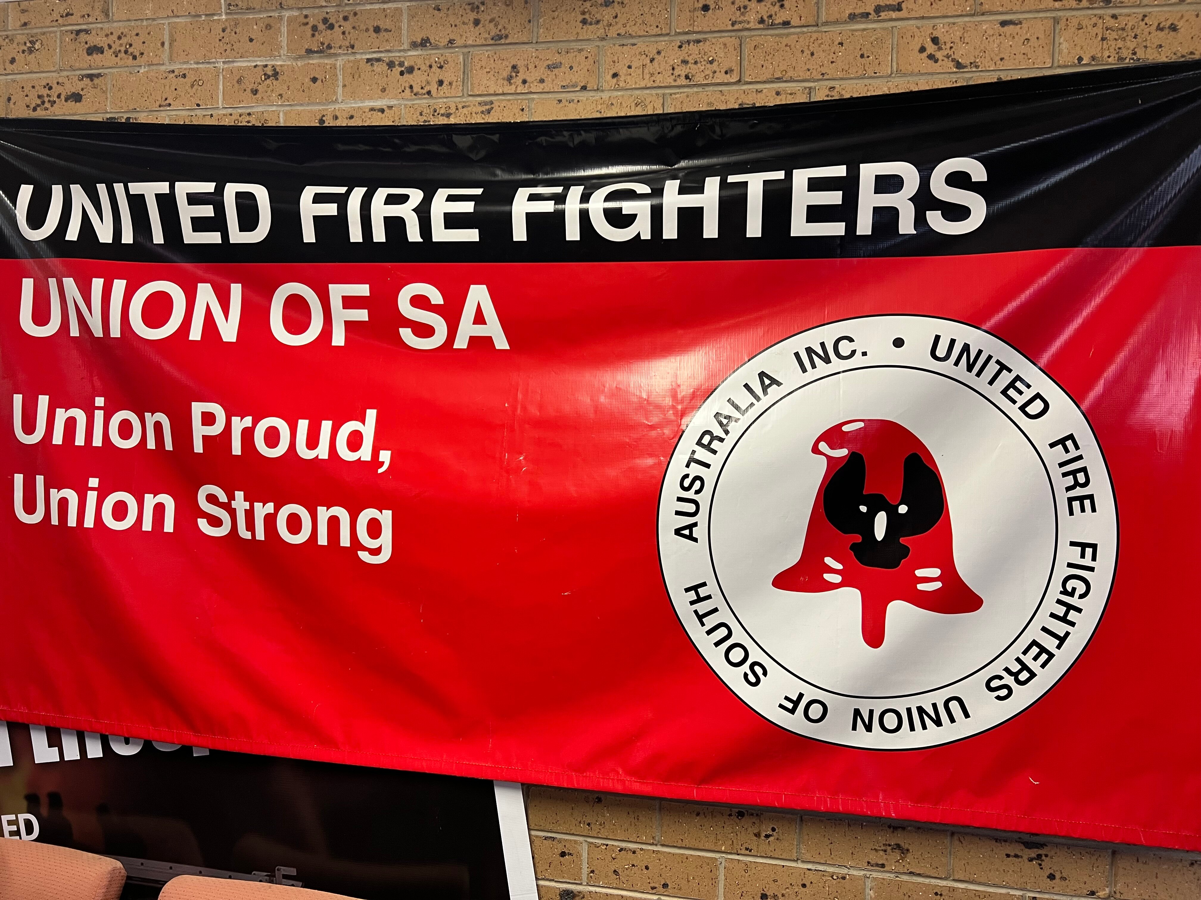 United Firefighters Union of SA is emblazoned on a red and black banner with a white union logo on the right.