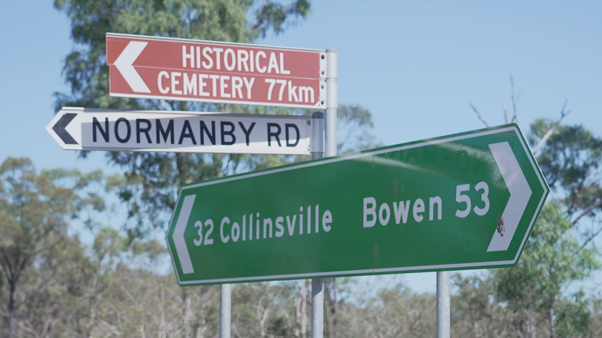 A road sign gives directions and distances to Bowen and Collinsville