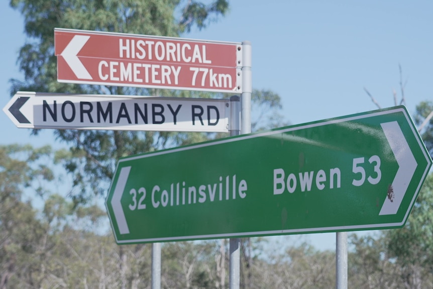 A road sign gives directions and distances to Bowen and Collinsville