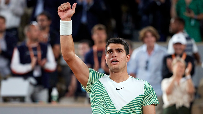 A Spanish tennis player gives a thumbs up to his fans in the crowd after winning a match at the French Open. 