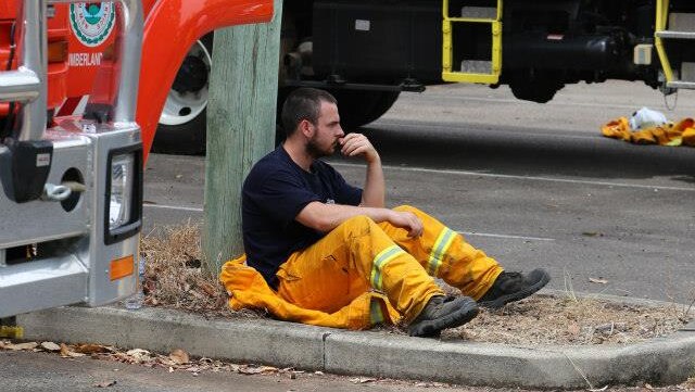 A firefighter takes a break after a night shift at Warrimoo