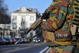A Belgian paratrooper stands guards outside the US embassy in Brussels