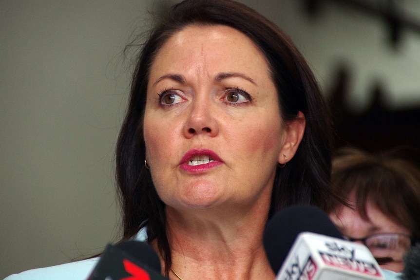 Liza Harvey speaks at a media conference.