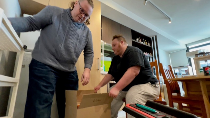 A photo of Lee (left) and Erin (right) packing boxes.