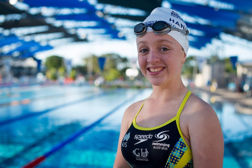 Tiffany Thomas Kane stands in front of the pool after a hard day's training.