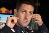 Jamie Whincup takes out his ear plugs in the team garage during a V8 Supercar race.