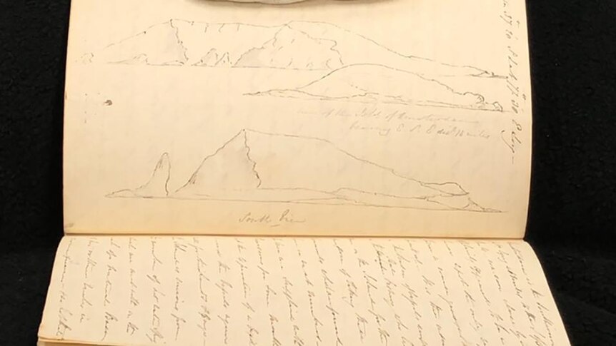 A diary with opened pages showing landscape drawing
