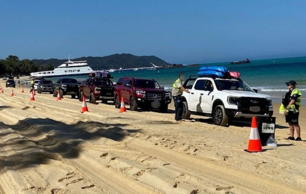 police stop a series of 4WDs on Moreton Island for a random breath test