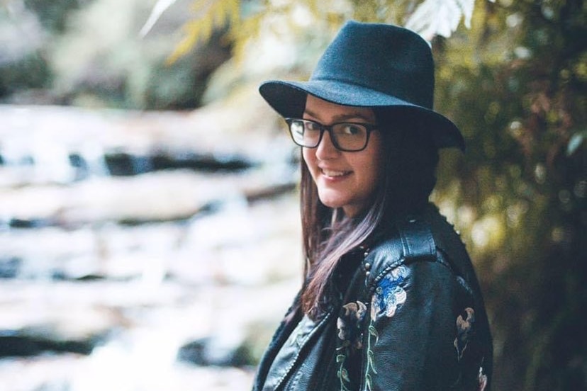 Sydney-based Anneliese wearing a black hat and jacket.