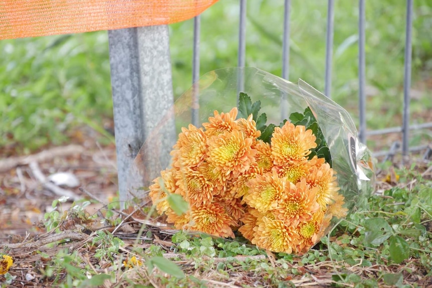 Flowers left for the female motorcyclist who was killed by the car.