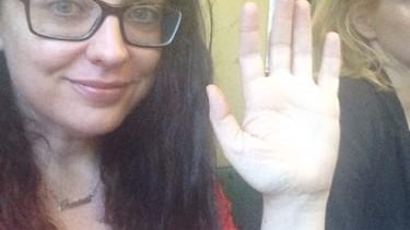 A woman holds up her hand with the caption #illridewithyou underneath