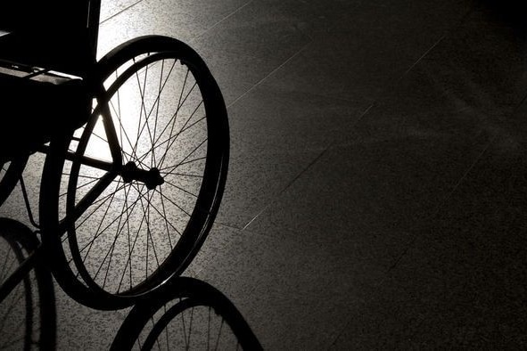 the shadow of a wheelchair in a dark room.