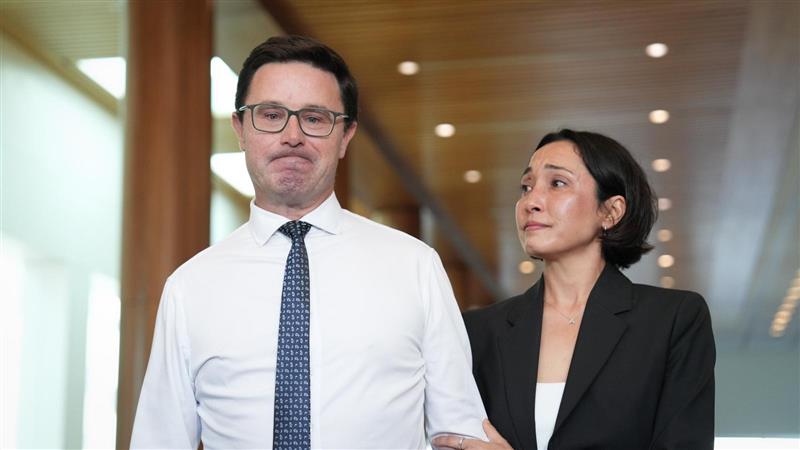 David and Amelia Littleproud hold each other in the Mural Hall.
