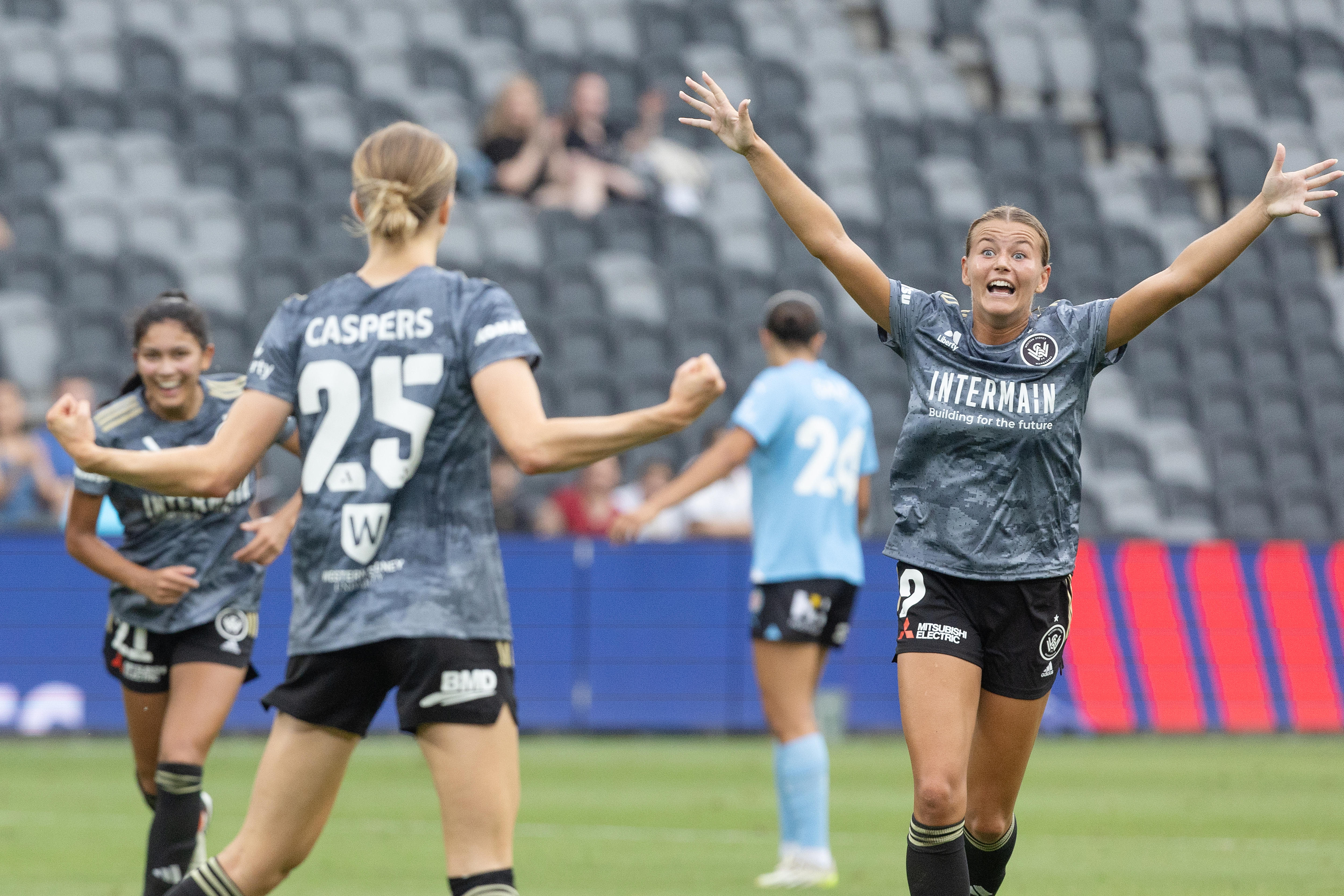 Sophie Harding celebrates a goal with teammates during an A-League Women game for the Western Sydney Wanderers.