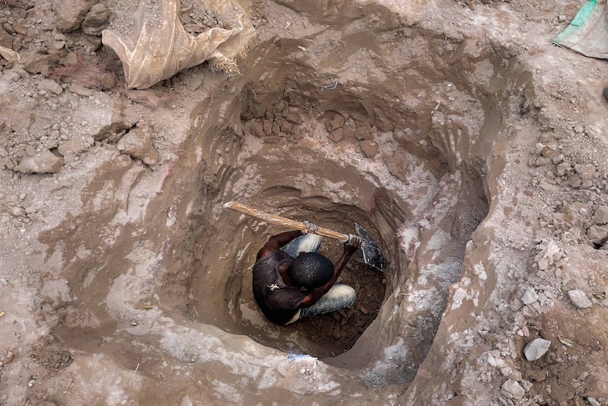 A man digs a tunnel.