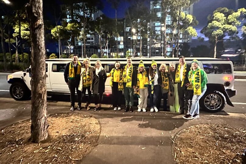 A group of Matildas fans pose with a stretch hummer. 