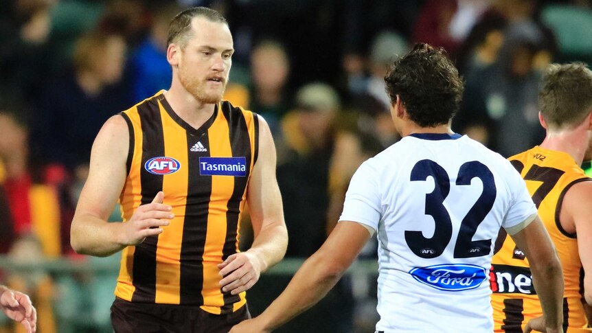 Hawthorn's Jarryd Roughead (L) with Geelong's Steve Motlop after preseason game in February 2017.