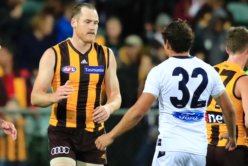 Hawthorn's Jarryd Roughead is congratulated by Geelong's Steve Motlop after an AFL preseason game