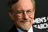Filmmaker Steven Spielberg poses at a movie premiere.