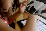 A child with autism uses an iPad