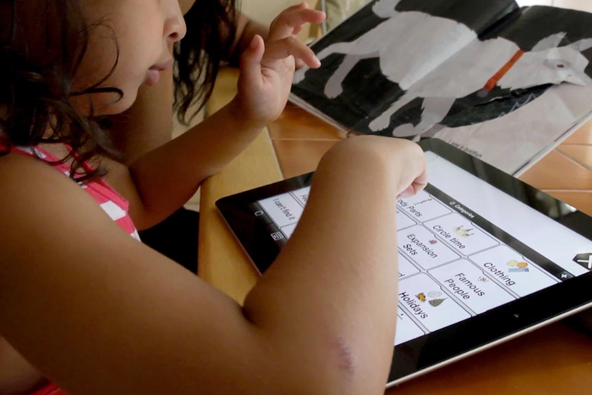 A child with autism uses an iPad