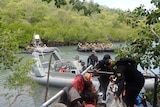 Australian Border Force boat pins a fishing boat against mangroves