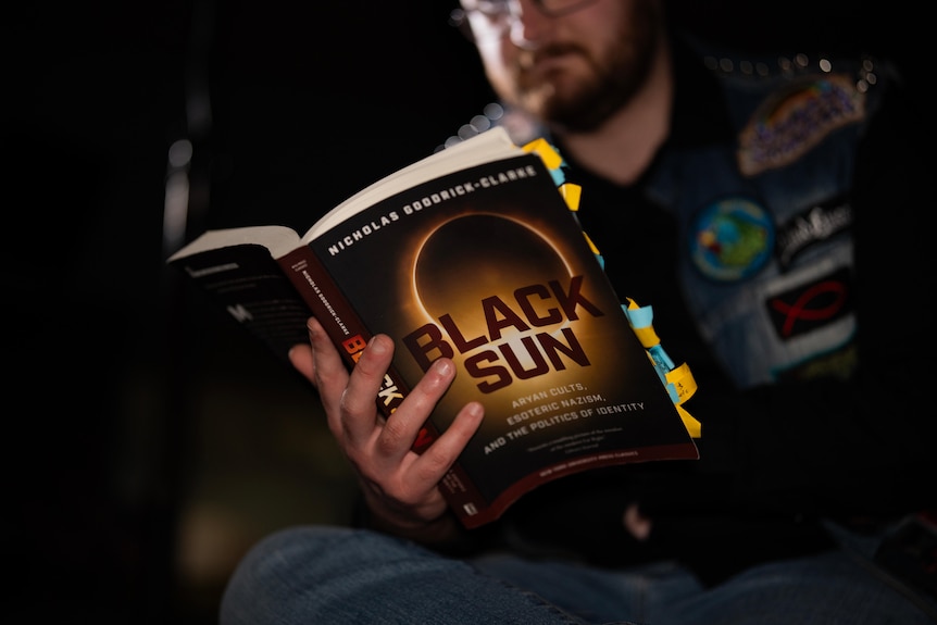 Picture of a man reading a book. 