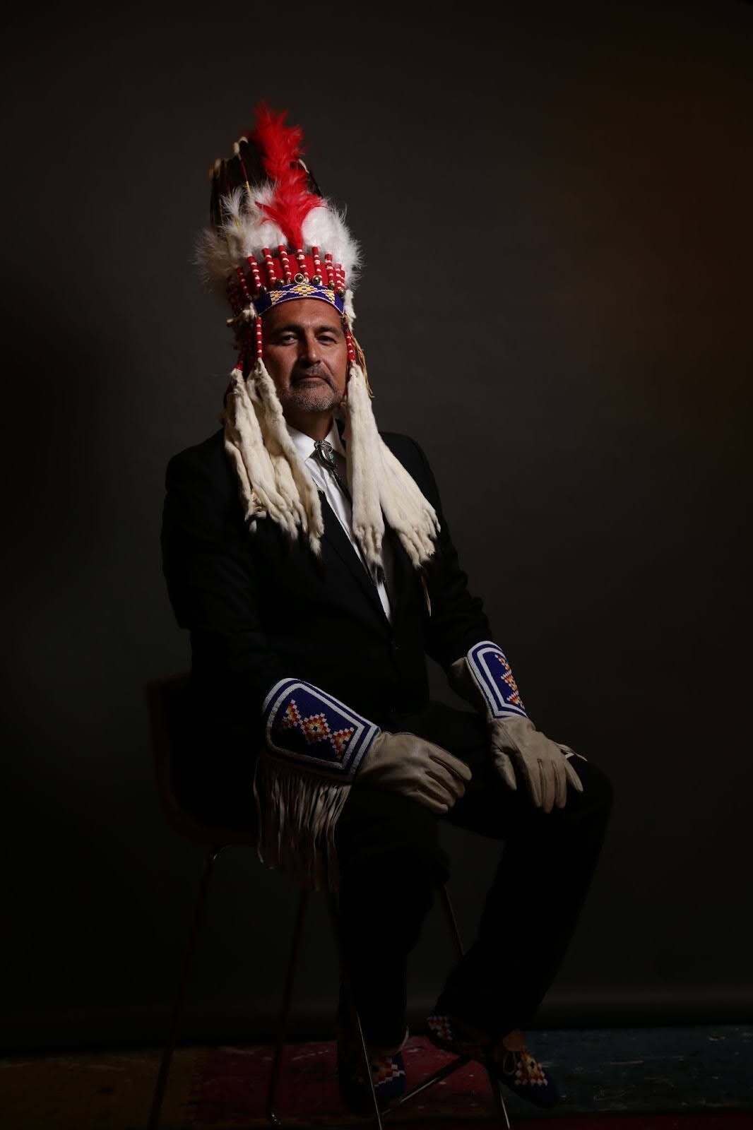 A person with an indigenous people of Siksika Nation (Canada) headdress