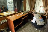 Palestinia journalists check the damage after Israeli soldiers entered the offices of the local Palestinian Al-Khalil radio