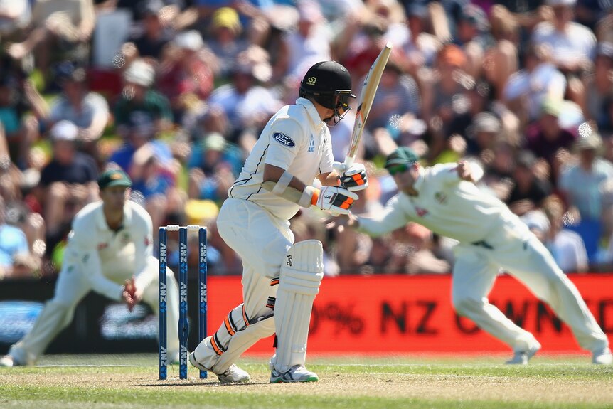 NZ's Tom Latham edges and is caught by Australia's Steve Smith on day one in Christchurch.