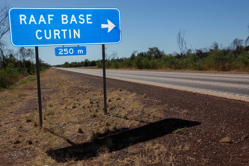 A sign next to a road reads "RAAF BASE CURTIN".