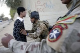 Iraqi soldier frisks man at Baghdad polling centre