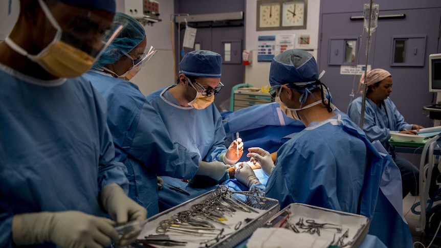 A surgeon and team performs an operation at St Vincent's Hospital