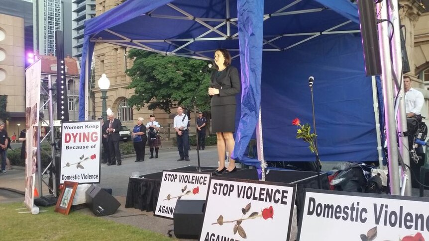 Politicians carried red roses to the rally held in Brisbane against domestic violence.