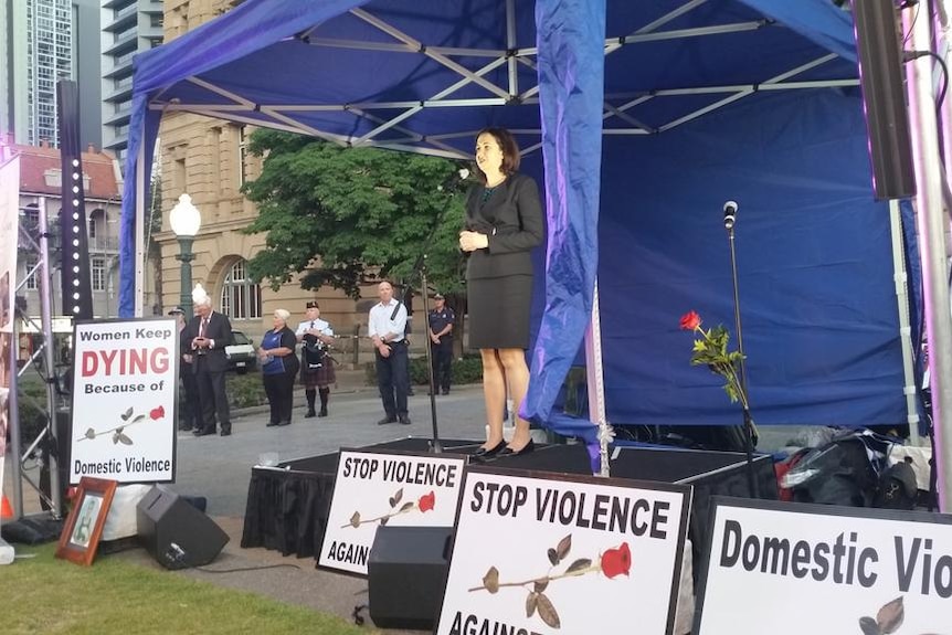 Politicians carried red roses to the rally held in Brisbane against domestic violence.